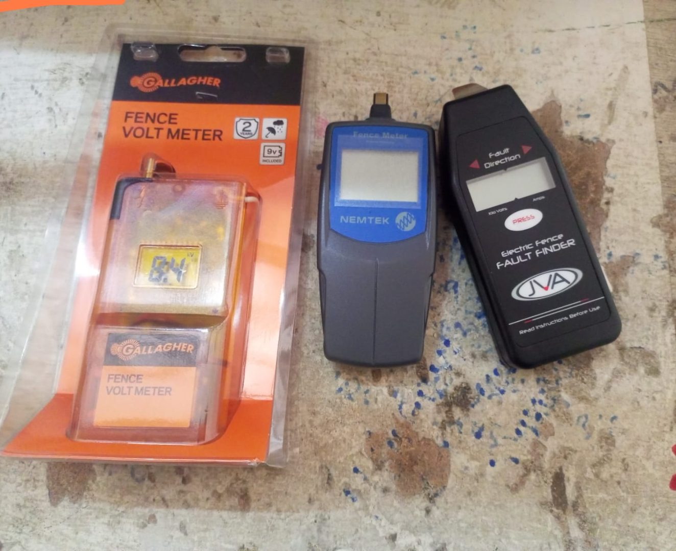 Gallagher and Nemtek fence volt meters beside a JVA electric fence fault finder